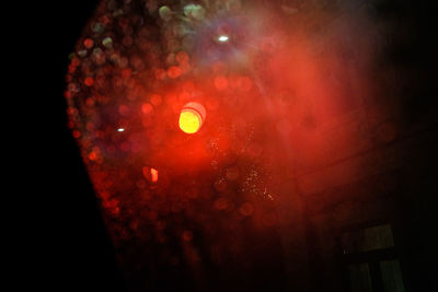 Low angle view of illuminated lights at night