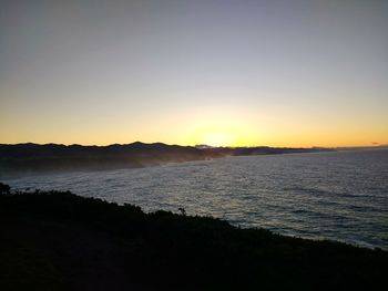 Scenic view of sea against clear sky during sunset