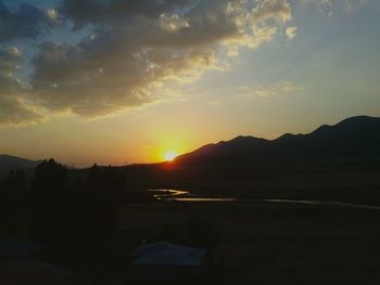 Scenic view of mountains against sky during sunset