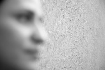 Close-up portrait of woman against wall