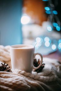 Close-up of coffee cup on sweater