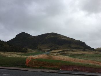 Scenic view of mountains against cloudy sky