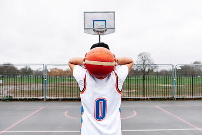 Portrait of unrecognizable male on a basketball court about to score. sport concept.