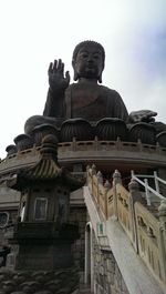 Low angle view of statue against temple