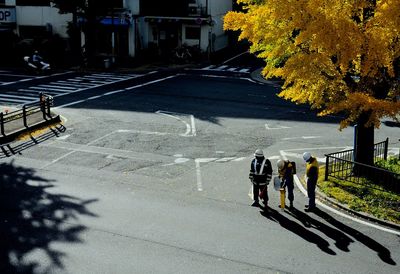 High angle view of worker standing on road during sunny day