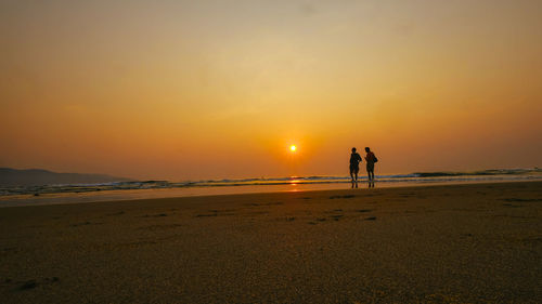 Scenic view of beach against sky during sunset