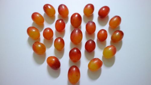 Close-up of tomatoes over white background