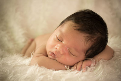 Cute baby boy sleeping on fur