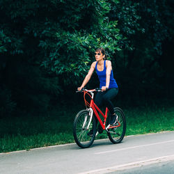 Woman riding bicycle on road