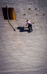 Low angle view of girl climbing wall