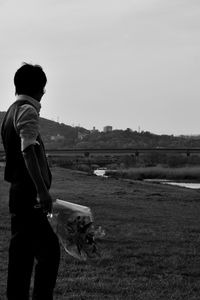 Man standing on field against clear sky