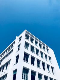 Low angle view of building against clear blue sky