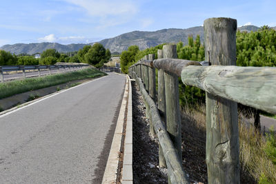 Road leading towards mountain against sky