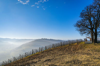 Scenic view of langhe landscape against blue sky