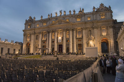 Seats arranged in front of st peters basilica in city at dusk