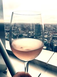 Close-up of beer glass on table against sky