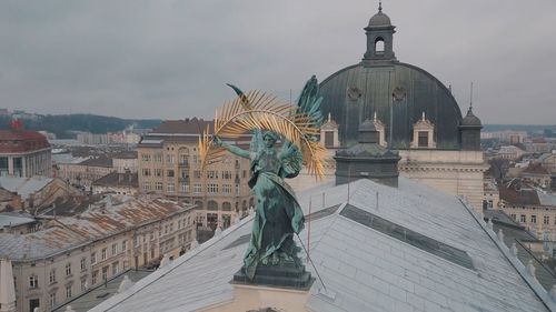 Statue of liberty against buildings in city