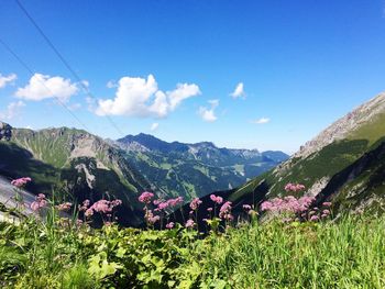 Scenic view of mountains against blue sky