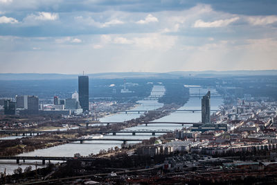 Bridge over river against buildings in city