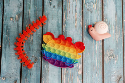 Children's toys on a wooden background, top view