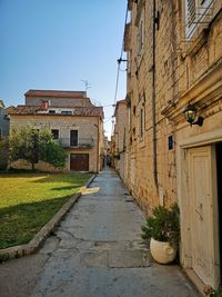 Narrow alley amidst buildings against sky