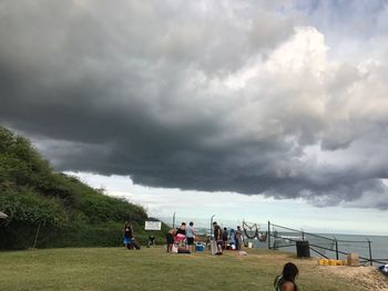 People playing soccer against sky