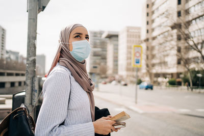 Portrait of woman standing on city street