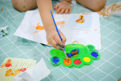 High angle view of girl playing on table