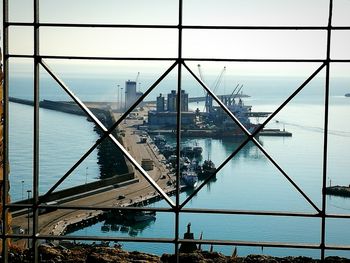 View of city by sea against sky