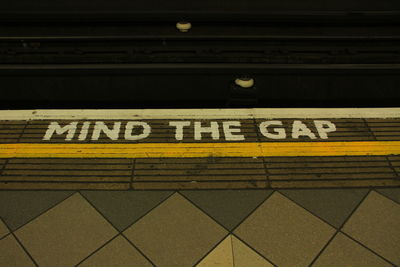 Text on illuminated subway station