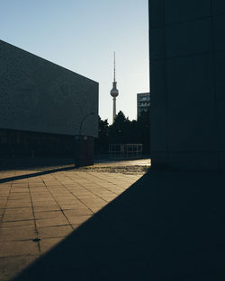 Mid distance view of communications tower against clear sky during sunset