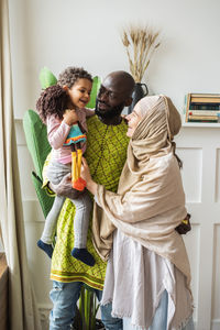 Friends standing with arms raised