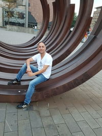 Portrait of young man sitting outdoors