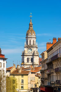 Low angle view of buildings against blue sky