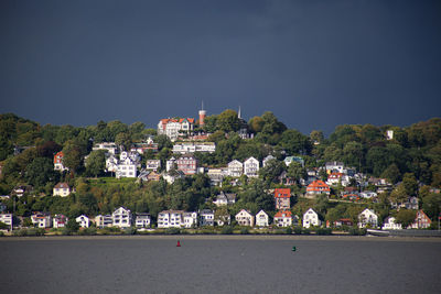 Buildings in town against clear sky