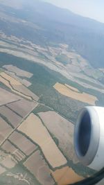 Aerial view of airplane wing over landscape