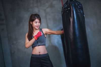 Female boxer punching bag