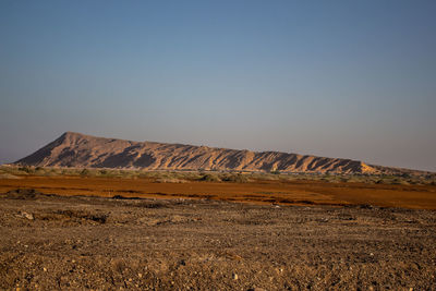 Scenic view of arid landscape against clear sky