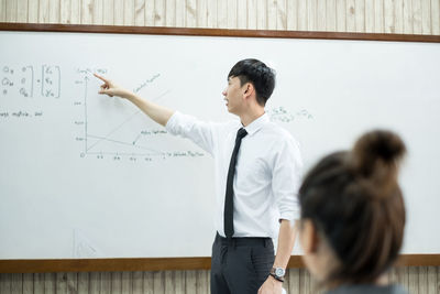 Teacher teaching student in classroom