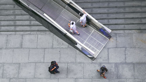 High angle view of people walking on staircase