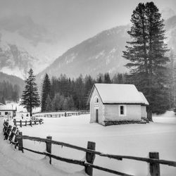 Built structure on snow covered landscape against sky