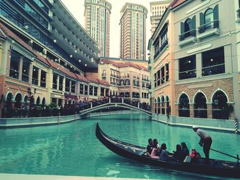 People on boat in city