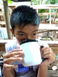 Portrait of boy drinking coffee