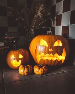 Illuminated pumpkins on table