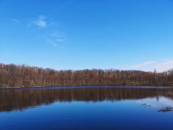 Scenic view of lake against blue sky