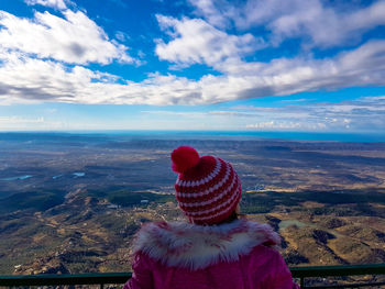Rear view of woman looking at sea against sky