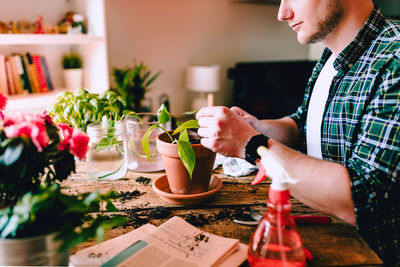 Side view of a man having food at table