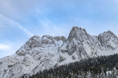 Low angle view of snowcapped mountain against sky