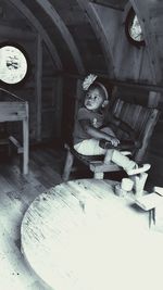 Portrait of boy sitting on wooden floor