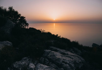 Scenic view of sea against sky during sunset